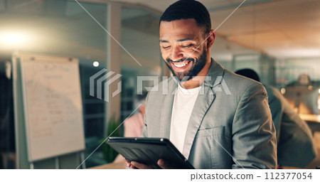 Tablet, meeting and happy business man in office, working on research project, schedule and planning. Night, corporate and worker on digital tech laugh for internet, website review and social media 112377054