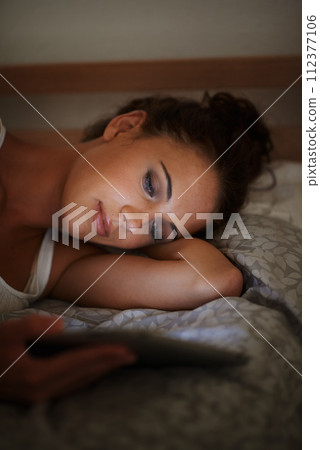 Woman, tablet and bed at night, scrolling and entertainment with tech and relaxing for peace before sleep. Female person, browsing and online for home, internet and elearning or social media Woman, tablet and bed at night, scrolling and entertainment with tech and relaxing for peace before sleep. Female person, browsing and online for home, internet and elearning or social media 112377106
