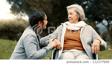 Caregiver helping woman with disability in park for support, trust and care in retirement. Nurse talking to happy senior patient in wheelchair for rehabilitation, therapy and conversation in garden Caregiver helping woman with disability in park for support, trust and care in retirement. Nurse talking to happy senior patient in wheelchair for rehabilitation, therapy and conversation in garden 112377600
