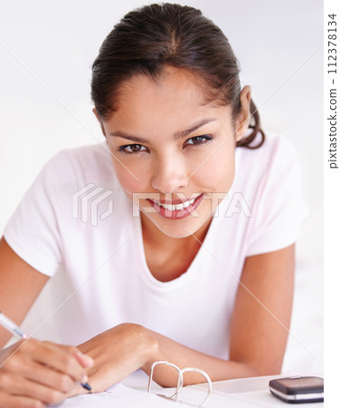 Woman, writer and planning in journal, portrait and inspiration or research in bed at home. Female person, author and writing notes in book for project, brainstorming and contemplation in bedroom 112378134