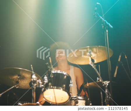 Man, drums and playing at concert in band for performance, show or party event at night. Male person, drummer or performer musician on base instrument for rock festival, audience or crowd of fans Man, drums and playing at concert in band for performance, show or party event at night. Male person, drummer or performer musician on base instrument for rock festival, audience or crowd of fans 112378145