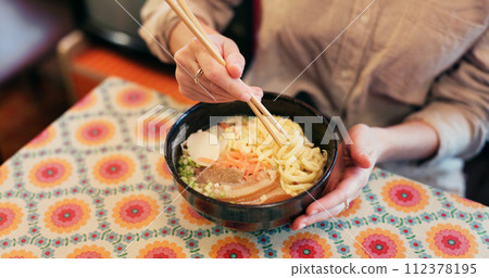Ramen food, plate and table in restaurant with person, hands and ginger with closeup for Japanese cuisine. Niboshi bowl, chopsticks and pork for diet, nutrition and catering for wellness in Tokyo 112378195