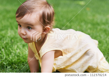 Sweet, grass and girl baby crawling, having fun and playing in backyard, park or garden. Nature, cute and kid, infant or toddler sitting on the lawn for child development senses outdoor at home. 112378214