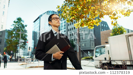 Walking, city and Asian business man with tablet, documents and file for morning commute in urban town. Professional, corporate worker and person thinking on travel for career, work and job in Japan 112378319