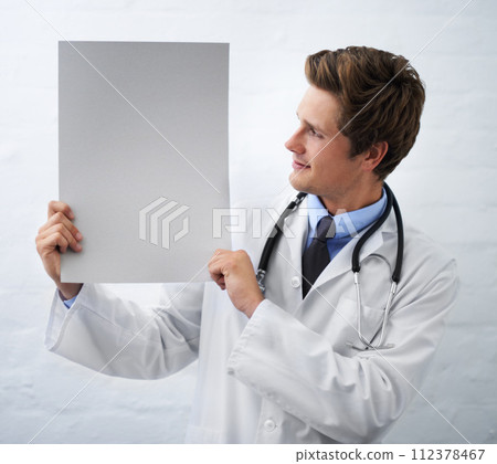 Man, doctor and billboard in healthcare for advertising or marketing on a white studio background. Male person, nurse or medical surgeon holding empty poster or blank sign for message on mockup space 112378467