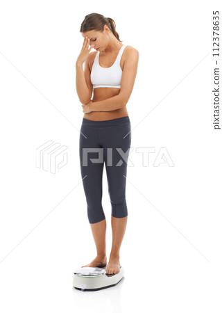 Scale, problem and woman disappointed in weight loss fail, negative exercise results and upset about bad fitness progress. Studio, crisis and person unhappy over mass, BMI or diet on white background Scale, problem and woman disappointed in weight loss fail, negative exercise results and upset about bad fitness progress. Studio, crisis and person unhappy over mass, BMI or diet on white background 112378635