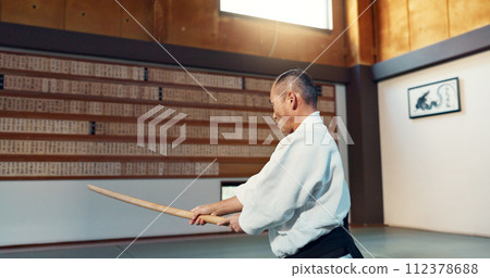 Aikido sword, mature sensei and man teaching class, self defense or combat technique. Martial arts, Japanese person and wooden weapon for skills development, attack demonstration or bokken strike Aikido sword, mature sensei and man teaching class, self defense or combat technique. Martial arts, Japanese person and wooden weapon for skills development, attack demonstration or bokken strike 112378688
