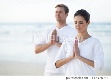 Couple, yoga and ocean with meditation, zen and waves on sand in morning with mindfulness in summer. Man, woman and outdoor for namaste with spiritual growth, balance or peace at beach in Cape Town 112378985