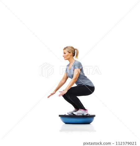 Woman, studio and squat with workout, ball or balance for legs, muscle development or profile by white background. Person, exercise and training for strong healthy body for vision, wellness or health 112379021