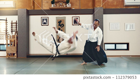 Aikido, sensei and fight with a master in martial arts with student in self defence, discipline and training. Demonstration, class or Japanese man with black belt in fighting with education of skill Aikido, sensei and fight with a master in martial arts with student in self defence, discipline and training. Demonstration, class or Japanese man with black belt in fighting with education of skill 112379053