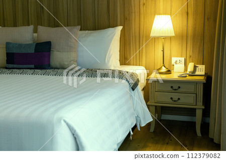 Luxurious Hotel Room with Comfortable Bedding and Elegant Interior Design Luxurious Hotel Room with Comfortable Bedding and Elegant Interior Design 112379082