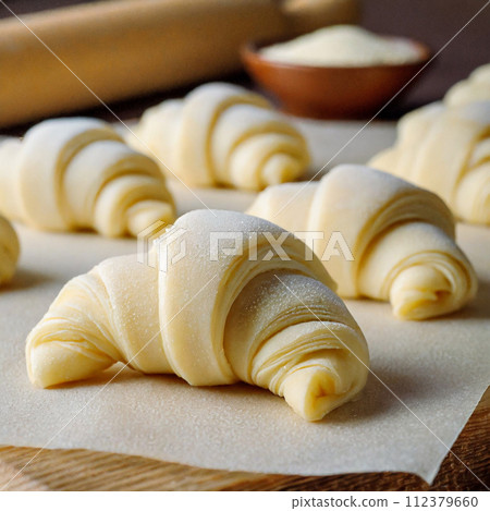 Croissant dough after forming and undergoing secondary fermentation before baking Croissant dough after forming and undergoing secondary fermentation before baking 112379660