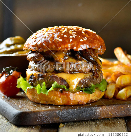 American cheese hamburger on a wooden board American cheese hamburger on a wooden board 112380322