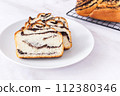 Pastry with poppy seeds, fresh bun on white plate, delicious bakery, light background, close up 112380346