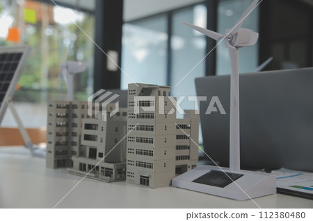 Close-up at tablet, Engineers pointing at tablet with their hands. To jointly design the use of renewable energy with wind and solar energy. Concept of using renewable energy. Close-up at tablet, Engineers pointing at tablet with their hands. To jointly design the use of renewable energy with wind and solar energy. Concept of using renewable energy. 112380480