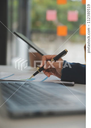 Teamwork with business people analysis cost graph on the desk in the meeting room. The business team discussed meetings and briefing strategies. Negotiation, Analysis, Discussion 112380519