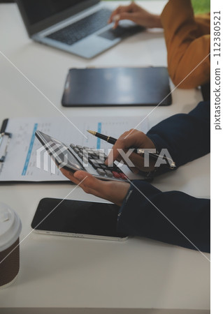 Teamwork with business people analysis cost graph on the desk in the meeting room. The business team discussed meetings and briefing strategies. Negotiation, Analysis, Discussion 112380521