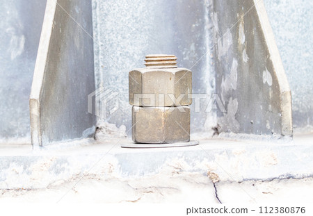 Old big Metal male square nut screw nail heads stackable to attach to large light pole bases. Bolts and screws. To attach structure of wall to be strong for house or various industrial.	 112380876