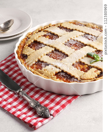 Homemade apple pie with apple jam on red napkin 112380969