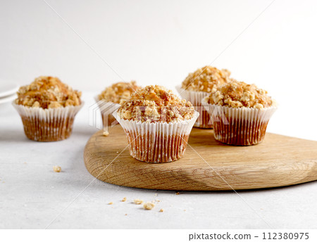 Tasty muffins closeup on a wooden board, selective focus. Tasty muffins closeup on a wooden board, selective focus. 112380975
