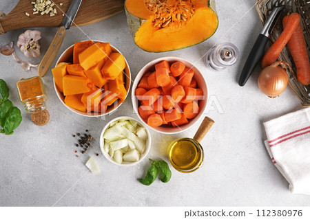 Ingredients for pumpkin soup on white background, ingredients for a healthy lunch Ingredients for pumpkin soup on white background, ingredients for a healthy lunch 112380976