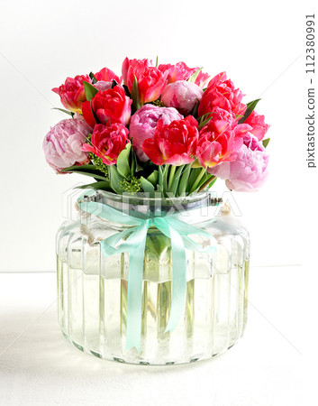 Beautiful pink peony flowers bouquet in glass vase on white background Beautiful pink peony flowers bouquet in glass vase on white background 112380991