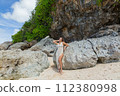 Beautiful young woman is happy  on the beach of Bali 112380998
