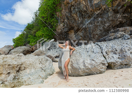 Beautiful young woman is happy  on the beach of Bali 112380998