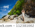 Beautiful young woman is happy on the beach of Bali 112381002