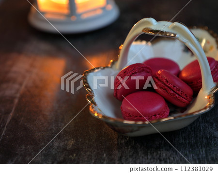 Macaroons and lantern moody food background. 112381029
