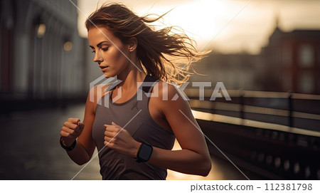 AI-generated content. Female runner checking smart watch while running, sunset light. AI-generated content. Female runner checking smart watch while running, sunset light. 112381798