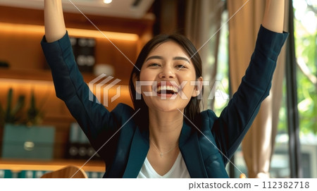 AI-generated content. Asian business woman standing on street expressing confidence and pride, raising hands, feeling power, motivation, and energy when celebrating career financial success in a big 112382718