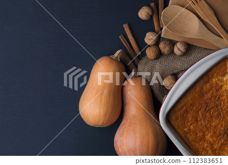 freshly baked pie on a dark table. rustic style. Cook at home. pumpkin pie. healthy food. Healthy freshly baked pie on a dark table. rustic style. Cook at home. pumpkin pie. healthy food. Healthy 112383651