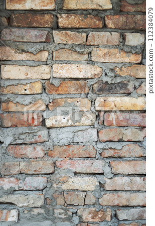 Old brick wall texture. The wall, made of old red bricks, darkened by old age. Brick wall 112384079