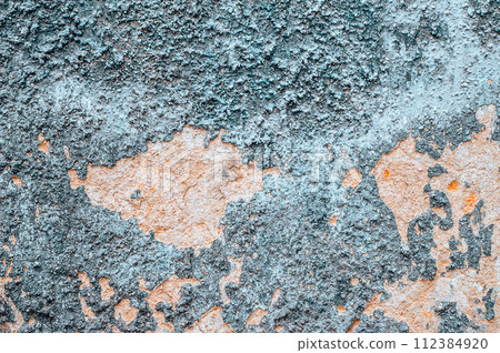 Old cracked weathered painted wall texture. Light peeled plaster wall with falling off flakes  112384920