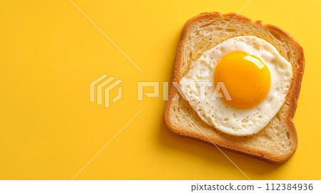toast with fried egg, pastel yellow background,copy space 112384936