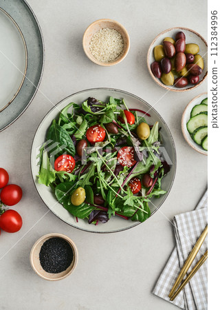 Salad with cherry tomato, olives, cucumber and arugula Salad with cherry tomato, olives, cucumber and arugula 112384996