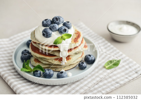 Plate blueberry pancakes with sour cream Plate blueberry pancakes with sour cream 112385032