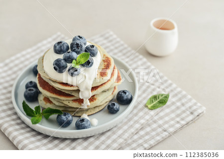 Plate blueberry pancakes with sour cream 112385036