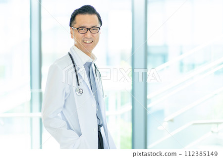 Senior male doctor working at a hospital Senior male doctor working at a hospital 112385149