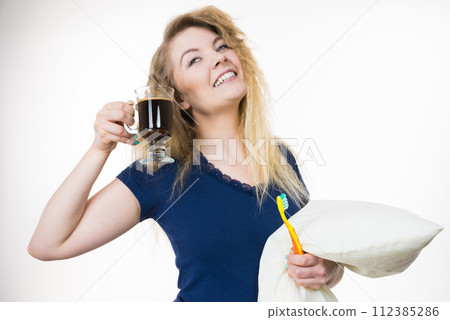 Happy woman holding toothbrush and coffee 112385286