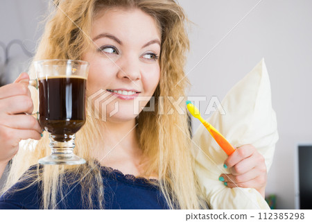 Funny woman being late drinking coffee 112385298
