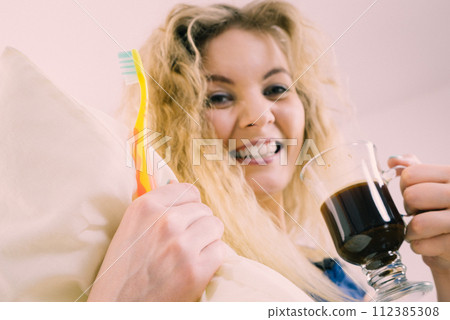 Funny woman being late drinking coffee 112385308