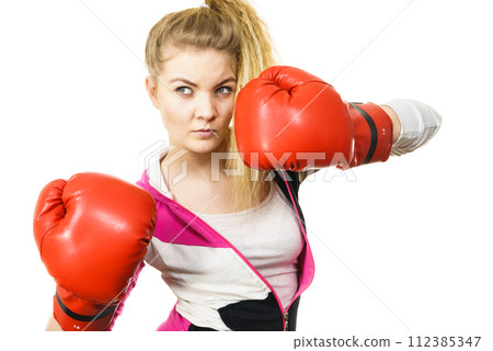 Woman wearing boxing gloves 112385347