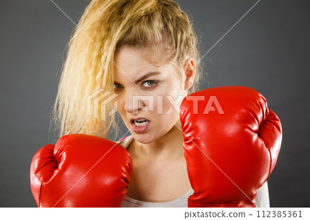 Angry woman wearing boxing gloves 112385361