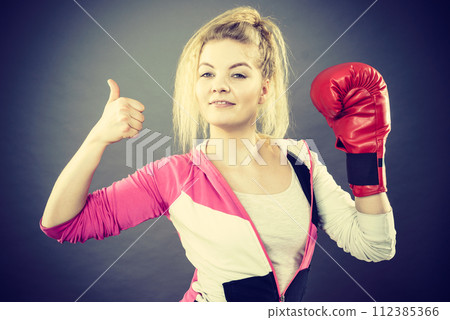 Woman wearing boxing gloves showing thumb up 112385366