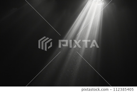 A single beam of light piercing through darkness, symbolizing hope and the possibility of finding a way out of the shadow of addiction and overdose 112385405