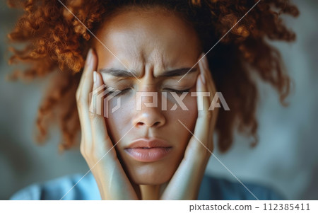 Headache from Stress: An individual massaging temples trying to alleviate tension and headache caused by stress Headache from Stress: An individual massaging temples trying to alleviate tension and headache caused by stress 112385411