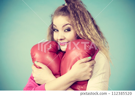 Funny girl in red gloves playing sports boxing 112385520
