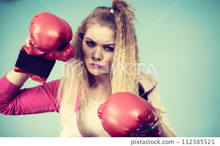 Cute girl in red gloves playing sports boxing 112385521